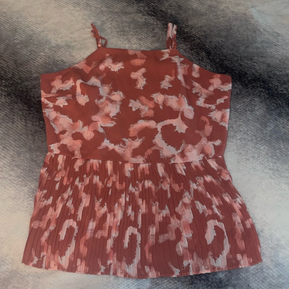 Halter strap top with a pleated bottom. The pattern is a light and white pink.